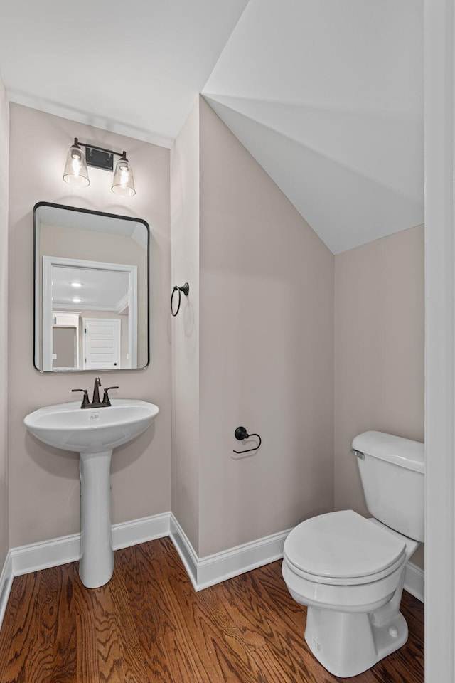 bathroom featuring hardwood / wood-style flooring, toilet, and sink