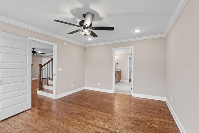 spare room with hardwood / wood-style floors, ceiling fan, and ornamental molding