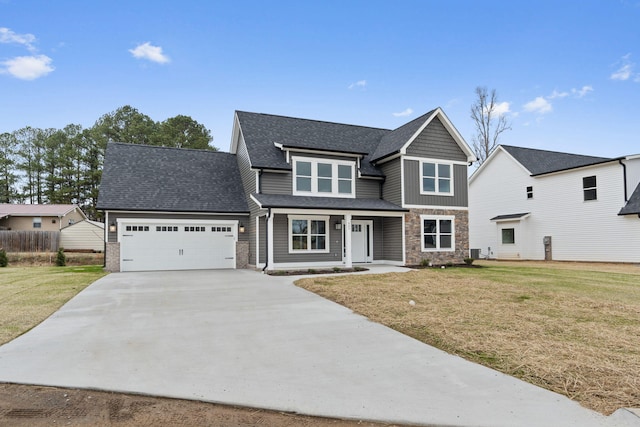 view of front of property featuring a front lawn and a garage