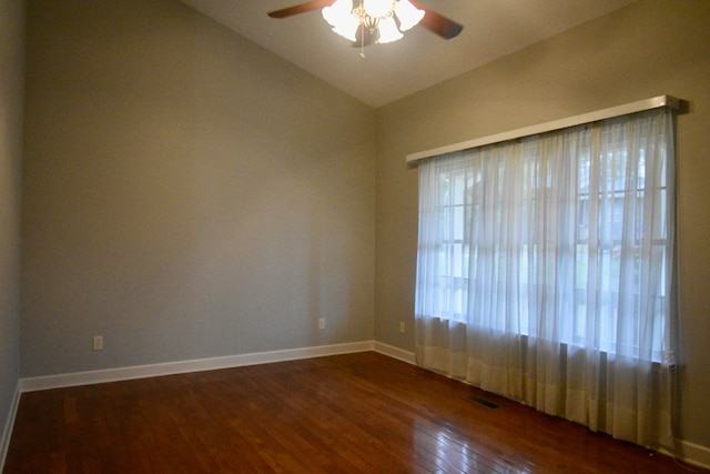 unfurnished room with ceiling fan, vaulted ceiling, and dark hardwood / wood-style floors