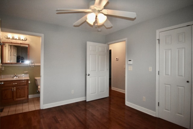 bedroom featuring dark hardwood / wood-style flooring, connected bathroom, and ceiling fan