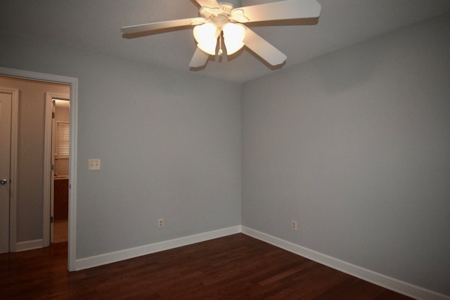 empty room featuring dark wood-type flooring and ceiling fan