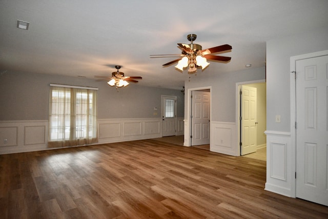 empty room with hardwood / wood-style floors and ceiling fan