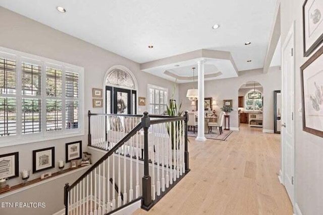 hall featuring a chandelier, light hardwood / wood-style flooring, and french doors