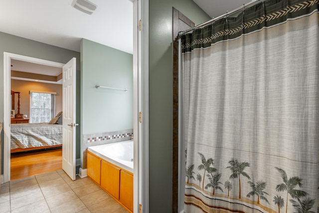 bathroom featuring separate shower and tub and tile patterned flooring