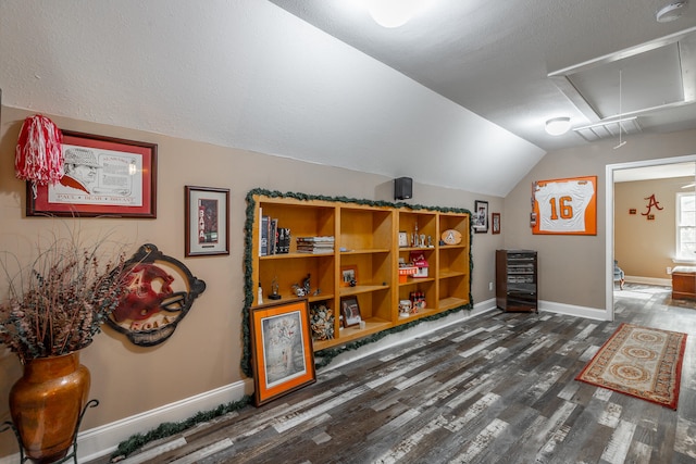 bonus room featuring dark hardwood / wood-style floors and lofted ceiling