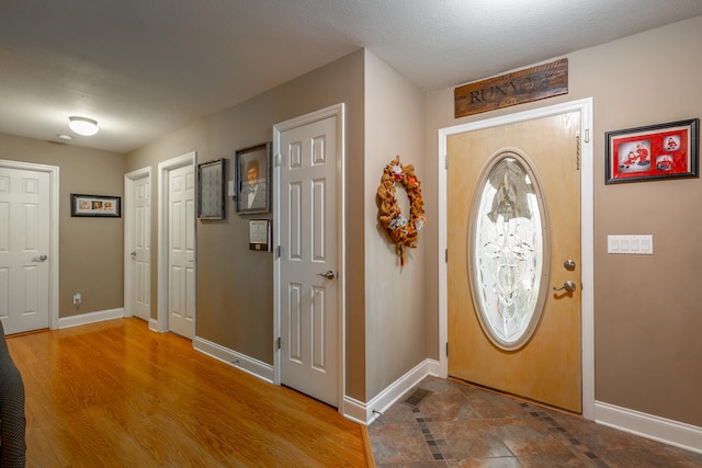 entrance foyer with hardwood / wood-style flooring and a textured ceiling