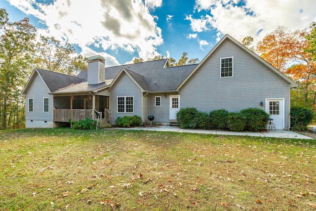 back of house featuring a yard and a patio