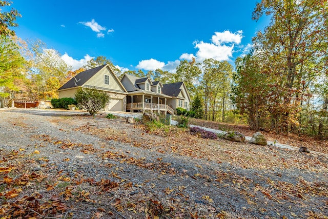 view of side of home featuring a porch and a garage