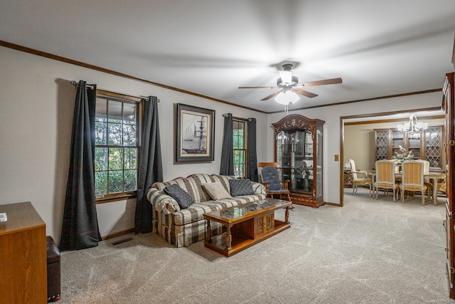 living room with ornamental molding, light carpet, and ceiling fan with notable chandelier