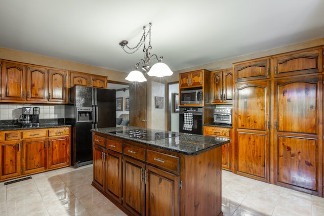 kitchen featuring decorative backsplash, a kitchen island, a chandelier, black appliances, and decorative light fixtures