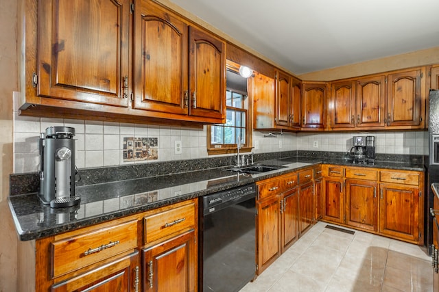 kitchen with dishwasher, dark stone counters, sink, light tile patterned flooring, and tasteful backsplash