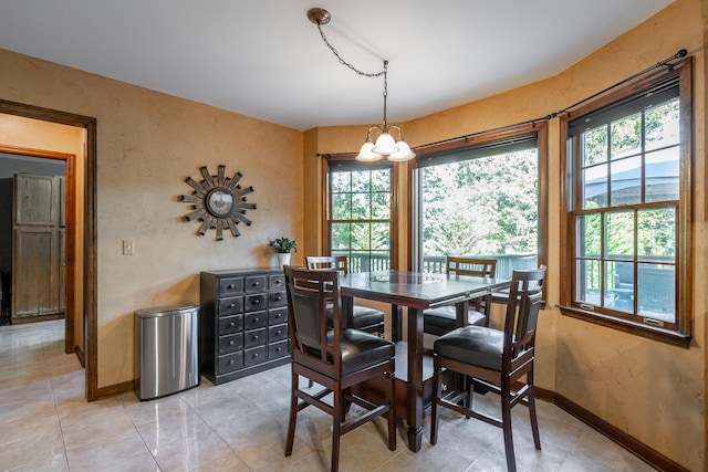 dining room with a notable chandelier and light tile patterned floors