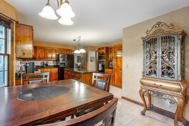 dining room featuring an inviting chandelier and light tile patterned floors