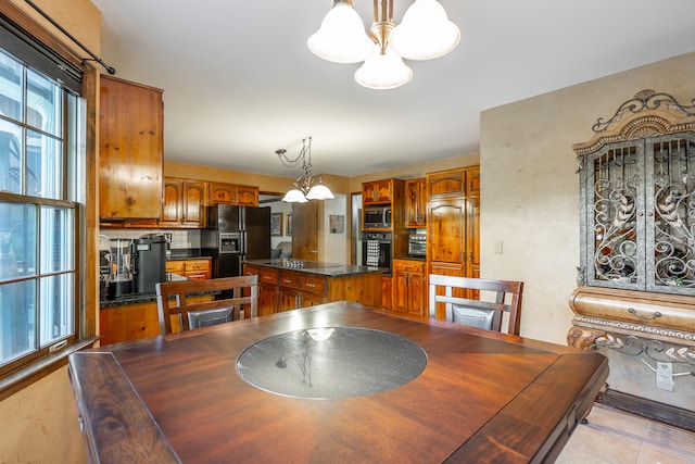 dining room with an inviting chandelier and light tile patterned floors