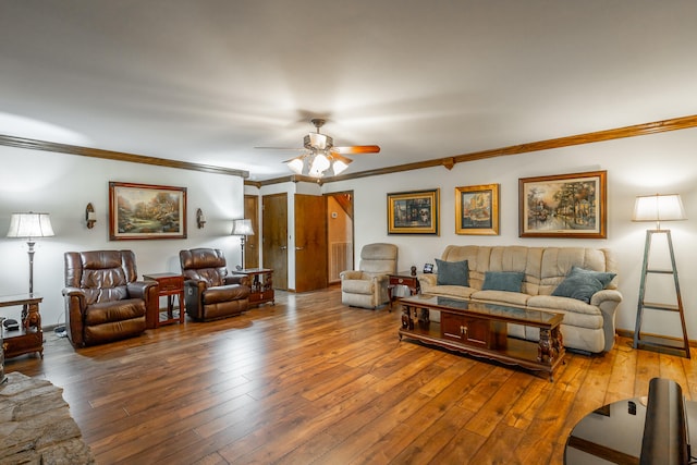 living room with ornamental molding, wood-type flooring, and ceiling fan