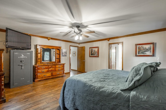 bedroom featuring ceiling fan, wood-type flooring, and ornamental molding