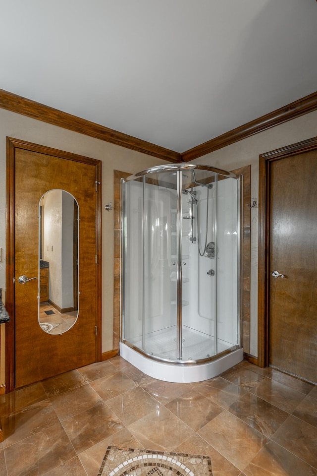 bathroom with ornamental molding and walk in shower