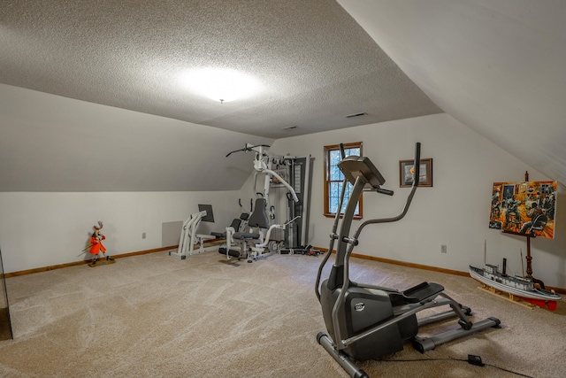 exercise room with lofted ceiling, a textured ceiling, and carpet floors