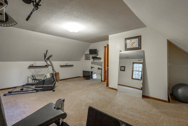 exercise area featuring light carpet, a textured ceiling, and lofted ceiling