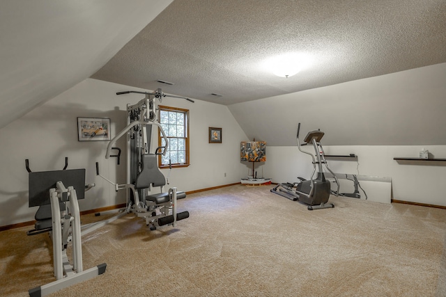 workout area with vaulted ceiling, a textured ceiling, and carpet flooring