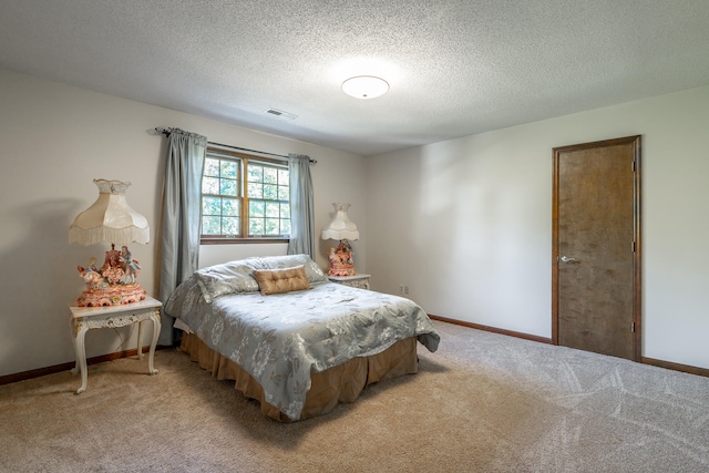 bedroom with light carpet and a textured ceiling