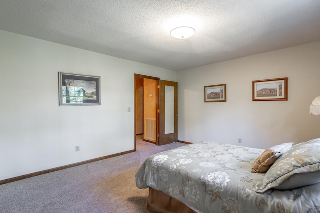 carpeted bedroom with a textured ceiling