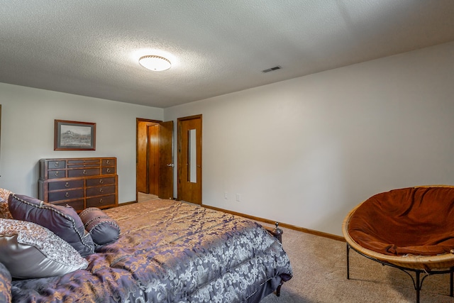 carpeted bedroom featuring a textured ceiling