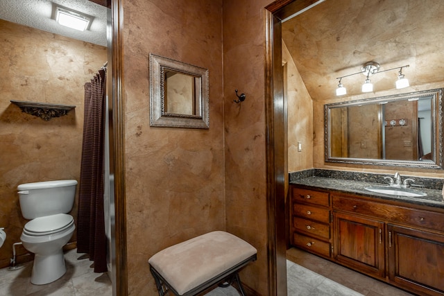 bathroom featuring vanity, curtained shower, toilet, and tile patterned floors