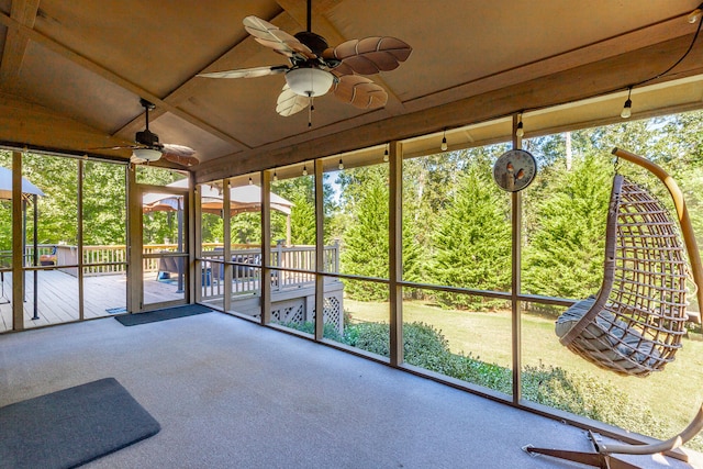 unfurnished sunroom with vaulted ceiling and ceiling fan