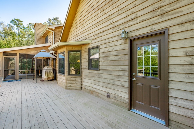 wooden deck with a sunroom