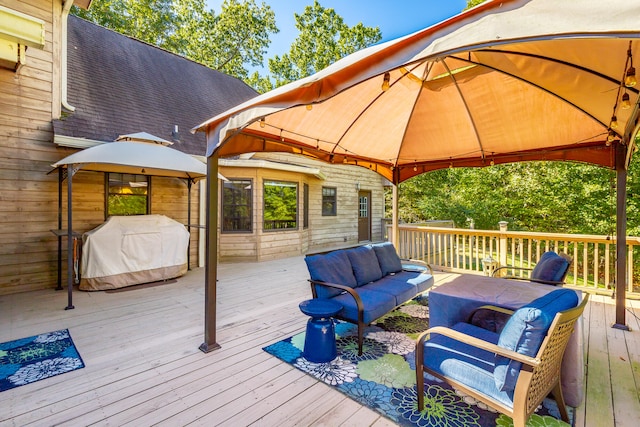 wooden deck featuring a gazebo, an outdoor hangout area, and grilling area