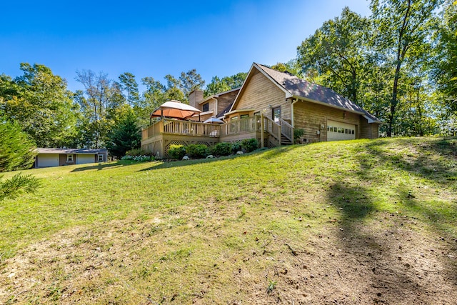 view of property exterior with a wooden deck, a lawn, and a garage