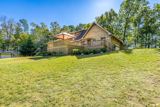 view of front facade with a front yard, a garage, and a deck