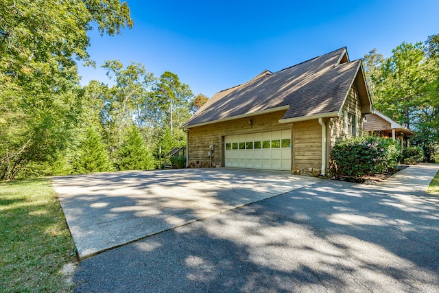 view of side of home featuring a garage