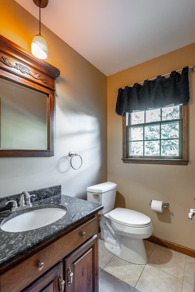 bathroom featuring vanity, toilet, and tile patterned floors