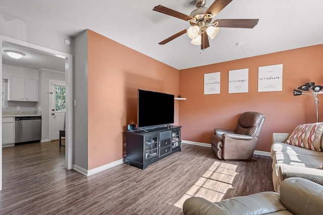 living room with dark hardwood / wood-style floors, a textured ceiling, and ceiling fan