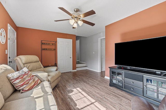 living room featuring wood-type flooring and ceiling fan