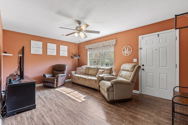 living room with a textured ceiling, hardwood / wood-style flooring, and ceiling fan