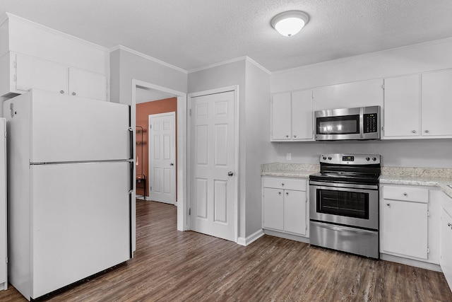 kitchen featuring appliances with stainless steel finishes, white cabinets, a textured ceiling, and dark wood-type flooring