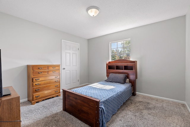 carpeted bedroom with a textured ceiling