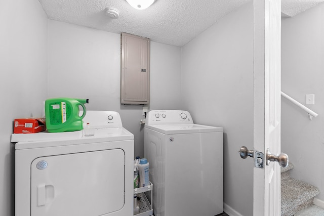 laundry area featuring independent washer and dryer, a textured ceiling, and electric panel