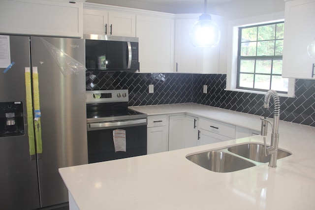 kitchen with tasteful backsplash, sink, stainless steel appliances, decorative light fixtures, and white cabinets