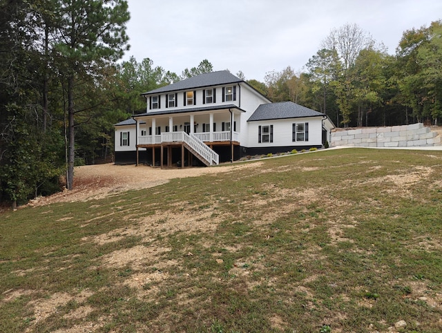 back of property with a porch and a yard