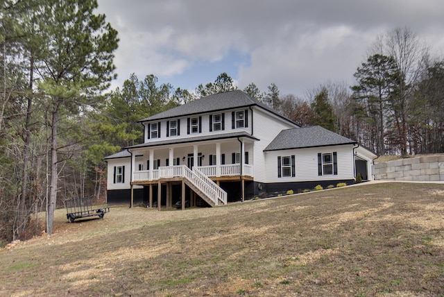 back of house with a lawn, a garage, and covered porch