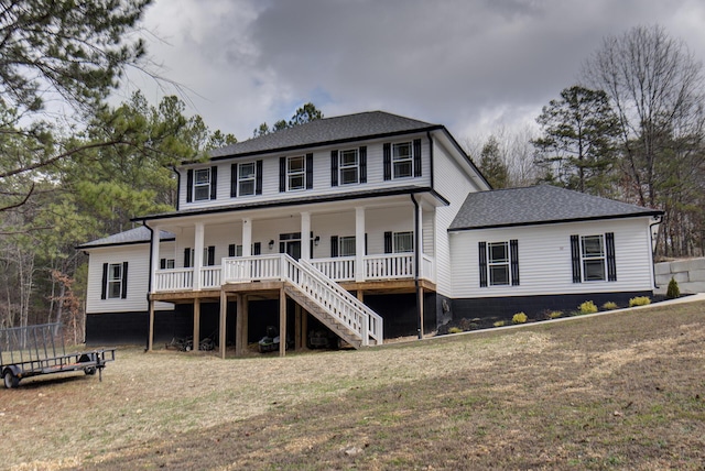 view of front of house featuring covered porch and a front yard