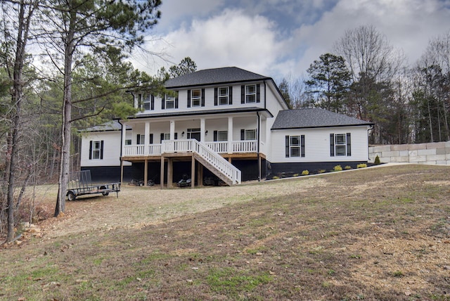 back of property featuring a porch and a lawn