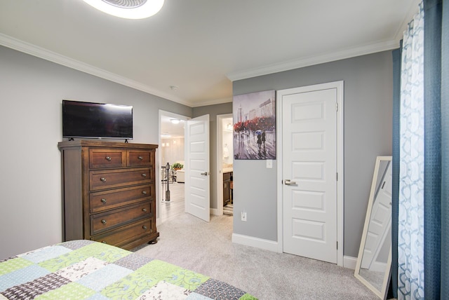 bedroom featuring connected bathroom, light colored carpet, and ornamental molding