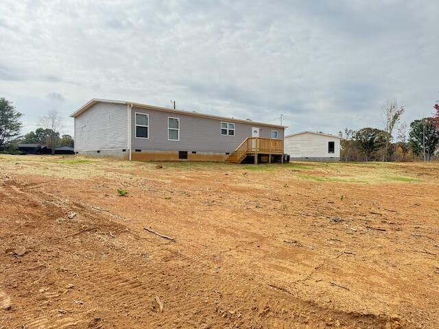 rear view of house with crawl space