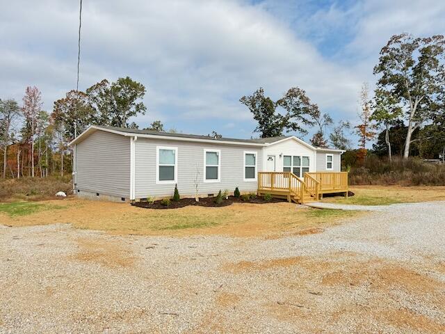 view of front of property featuring crawl space and a wooden deck